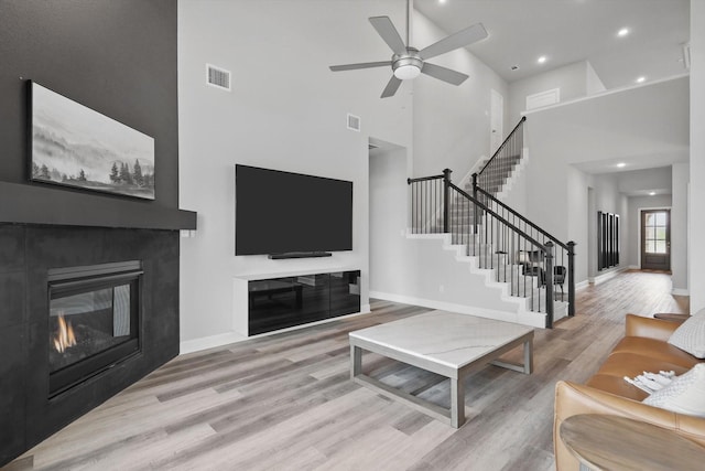 1302 20th St, Northlake, TX 76226 - living area with wood finished floors, stairs, a high ceiling, a ceiling fan, and baseboards