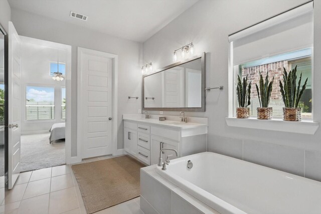 1302 20th St, Northlake, TX 76226 - ensuite bathroom featuring a bathtub, double vanity, and tile patterned floors