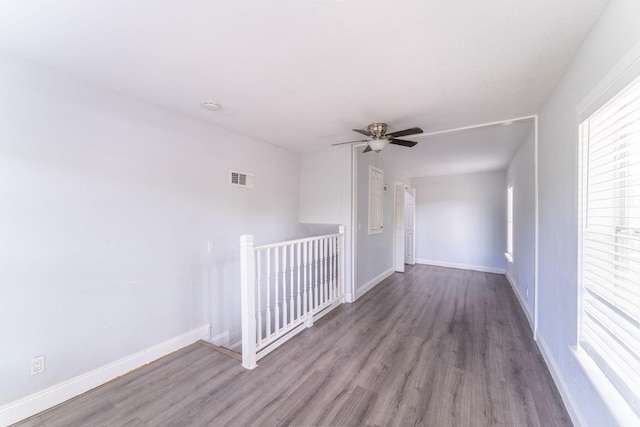 2835 Gladstone Dr, Dallas, TX 75211 - empty room with wood finished floors, baseboards, and a ceiling fan
