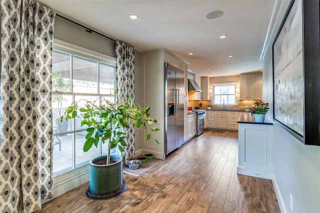 3241 Merrell Cir, Dallas, TX 75229 - kitchen with premium appliances, dark countertops, a sink, wood finished floors, and ventilation hood