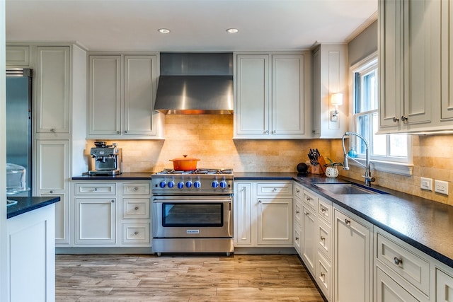 3241 Merrell Cir, Dallas, TX 75229 - kitchen with stainless steel range, wall chimney range hood, a sink, dark countertops, and recessed lighting