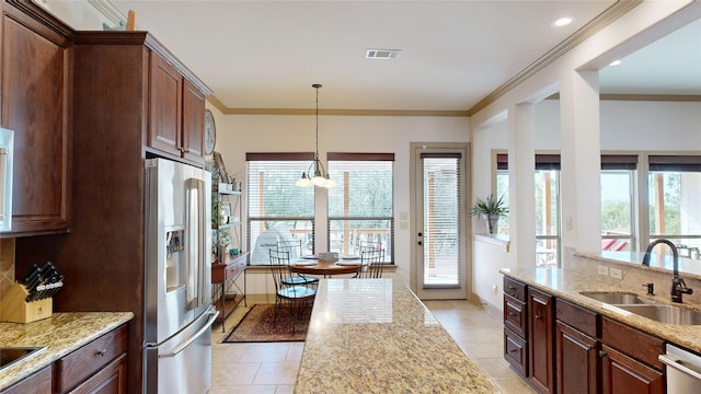 35 Oakland Hills Ct, Graford, TX 76449 - kitchen with appliances with stainless steel finishes, a sink, plenty of natural light, light tile patterned floors, and crown molding