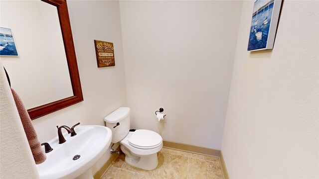 35 Oakland Hills Ct, Graford, TX 76449 - bathroom featuring a sink, toilet, baseboards, and tile patterned floors
