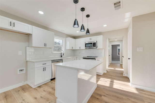 4955 Odessa Ave, Fort Worth, TX 76133 - kitchen with appliances with stainless steel finishes, white cabinetry, backsplash, light wood-type flooring, and recessed lighting