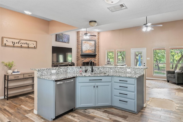 483 County Road 1591, Sunset, TX 76270 - kitchen featuring open floor plan, stainless steel dishwasher, a sink, a ceiling fan, and light wood finished floors