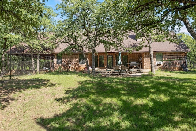 483 County Road 1591, Sunset, TX 76270 - rear view of property with a lawn, brick siding, and a patio