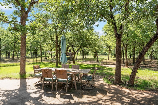 483 County Road 1591, Sunset, TX 76270 - view of patio / terrace with outdoor dining space and view of wooded area