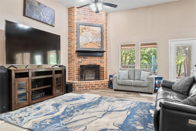 483 County Road 1591, Sunset, TX 76270 - living room with ceiling fan, a fireplace, wood finished floors, and a high ceiling