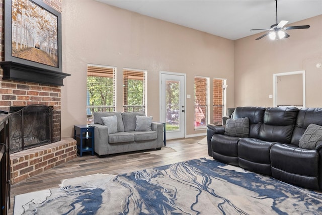 483 County Road 1591, Sunset, TX 76270 - living room featuring high vaulted ceiling, wood finished floors, ceiling fan, and a brick fireplace