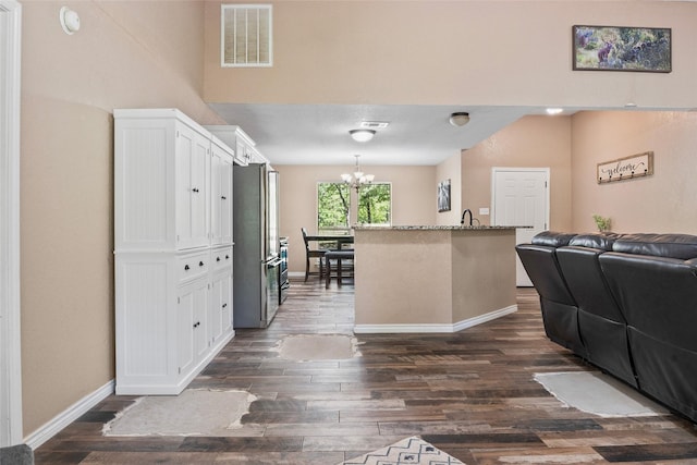 483 County Road 1591, Sunset, TX 76270 - kitchen featuring open floor plan, white cabinets, a chandelier, baseboards, and freestanding refrigerator