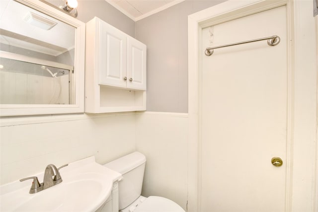 307 Smith St, Hillsboro, TX 76645 - bathroom with a sink, ornamental molding, toilet, and a shower