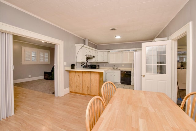 307 Smith St, Hillsboro, TX 76645 - kitchen with black dishwasher, a sink, under cabinet range hood, light countertops, and ornamental molding