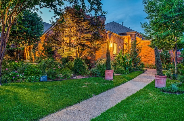 10 Carmarthen Ct, Dallas, TX 75225 - view of property exterior with a lawn, a shingled roof, and a chimney