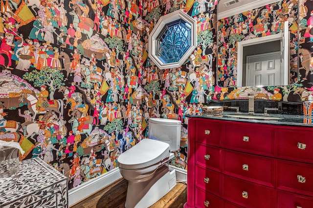 10 Carmarthen Ct, Dallas, TX 75225 - bathroom featuring toilet, vanity, wood finished floors, and wallpapered walls