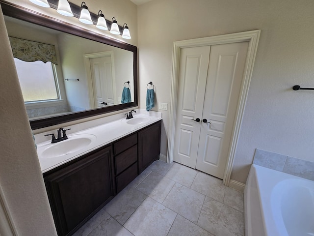 9924 Chrysalis Dr, Fort Worth, TX 76131 - bathroom with double vanity, a garden tub, baseboards, and tile patterned floors