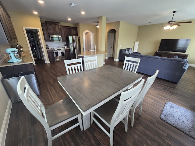 9924 Chrysalis Dr, Fort Worth, TX 76131 - dining room featuring arched walkways, ceiling fan, dark wood-style floors, recessed lighting, and baseboards