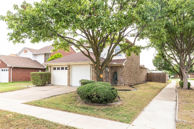 6900 Tudor Dr, Plano, TX 75023 - view of front facade featuring brick siding, driveway, and a garage