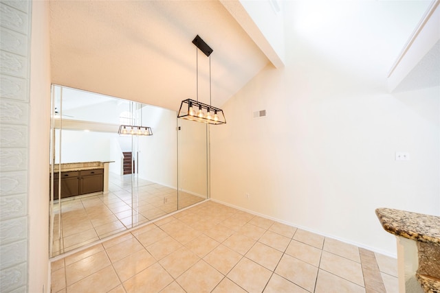 6900 Tudor Dr, Plano, TX 75023 - unfurnished dining area with light tile patterned floors, vaulted ceiling, and baseboards