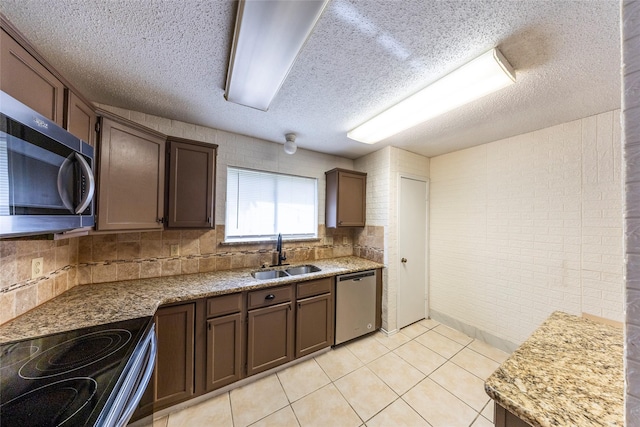 6900 Tudor Dr, Plano, TX 75023 - kitchen with appliances with stainless steel finishes, a sink, a textured ceiling, light tile patterned floors, and decorative backsplash