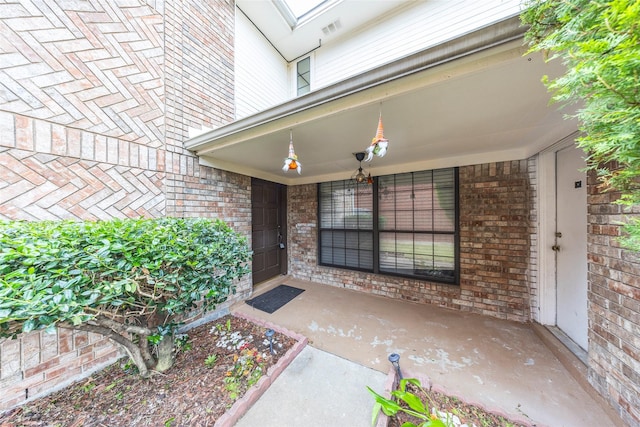 6900 Tudor Dr, Plano, TX 75023 - view of exterior entry with covered porch and brick siding