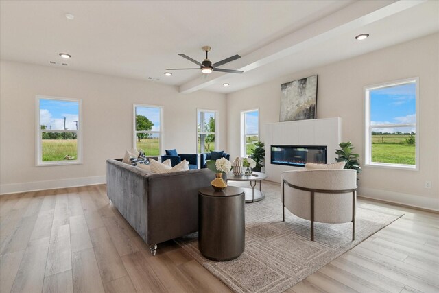 669 Massey Rd, Gunter, TX 75058 - living area featuring light wood-style flooring, a glass covered fireplace, a ceiling fan, recessed lighting, and baseboards