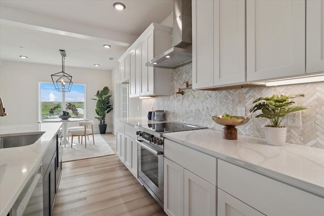 669 Massey Rd, Gunter, TX 75058 - kitchen featuring wall chimney range hood, stainless steel appliances, a sink, light wood-type flooring, and tasteful backsplash