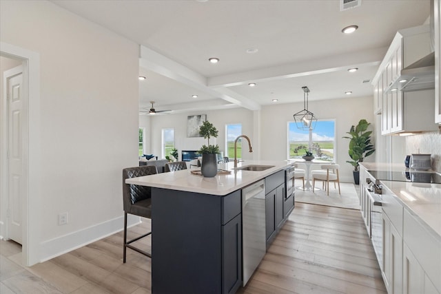 669 Massey Rd, Gunter, TX 75058 - kitchen with a sink, light wood-type flooring, a kitchen breakfast bar, light countertops, and appliances with stainless steel finishes