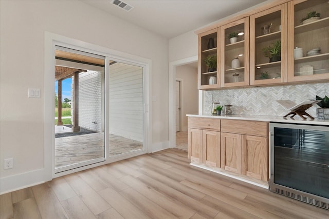 669 Massey Rd, Gunter, TX 75058 - indoor bar with beverage cooler, baseboards, light wood-type flooring, and backsplash