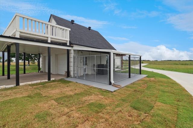 669 Massey Rd, Gunter, TX 75058 - back of house featuring a shingled roof, a garage, a yard, a balcony, and brick siding