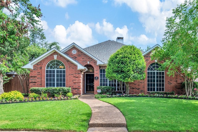 2203 Glascow Ct, Carrollton, TX 75007 - traditional-style home with brick siding, a chimney, and a shingled roof