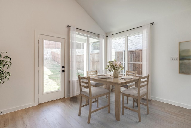 7136 Intrepid Dr, Fort Worth, TX 76179 - dining room with light wood-style flooring, vaulted ceiling, and baseboards