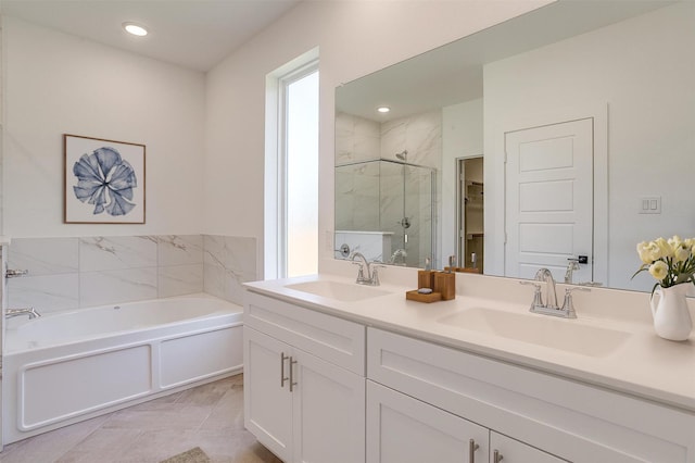 7136 Intrepid Dr, Fort Worth, TX 76179 - bathroom with a stall shower, a bath, double vanity, a spacious closet, and recessed lighting