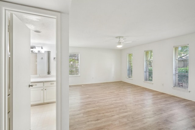 4016 Willow Ridge Dr, Dallas, TX 75244 - empty room featuring ceiling fan, light wood-style floors, and plenty of natural light