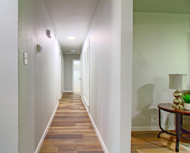 3404 Alhambra Dr, Forest Hill, TX 76119 - hallway with wood finished floors, baseboards, a textured wall, and recessed lighting