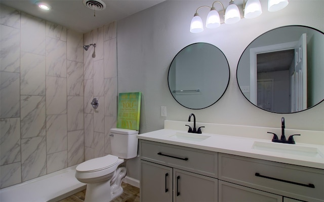 3404 Alhambra Dr, Forest Hill, TX 76119 - bathroom with double vanity, toilet, and a tile shower