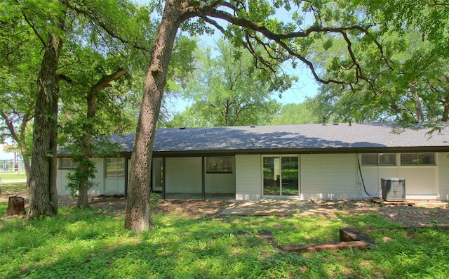 3404 Alhambra Dr, Forest Hill, TX 76119 - back of house with brick siding, central air condition unit, and roof with shingles