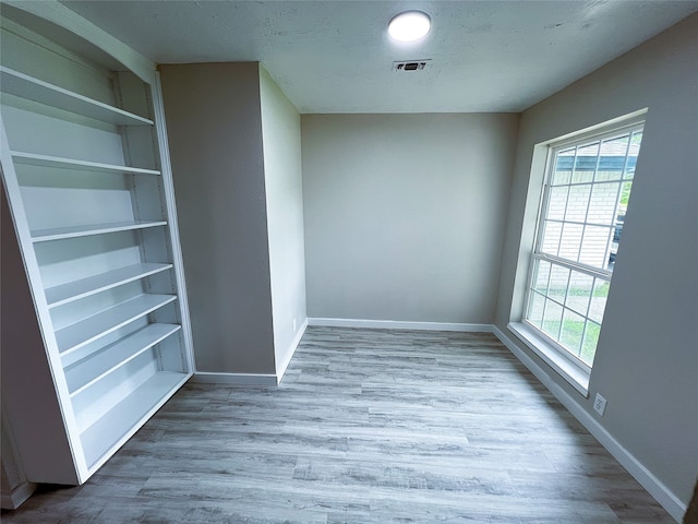 2946 Ridgewood Dr, Grapevine, TX 76051 - spare room with plenty of natural light, baseboards, and wood finished floors