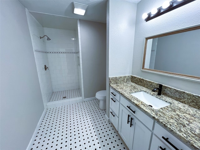 2946 Ridgewood Dr, Grapevine, TX 76051 - full bath with toilet, vanity, a tile shower, baseboards, and tile patterned floors