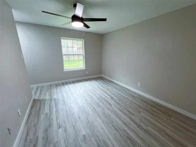 2946 Ridgewood Dr, Grapevine, TX 76051 - empty room with wood finished floors, a ceiling fan, and baseboards