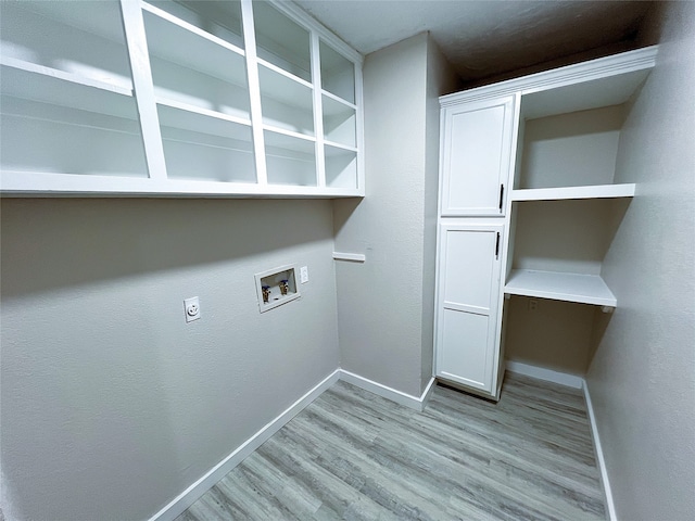 2946 Ridgewood Dr, Grapevine, TX 76051 - laundry room featuring cabinet space, hookup for a washing machine, light wood-type flooring, baseboards, and electric dryer hookup