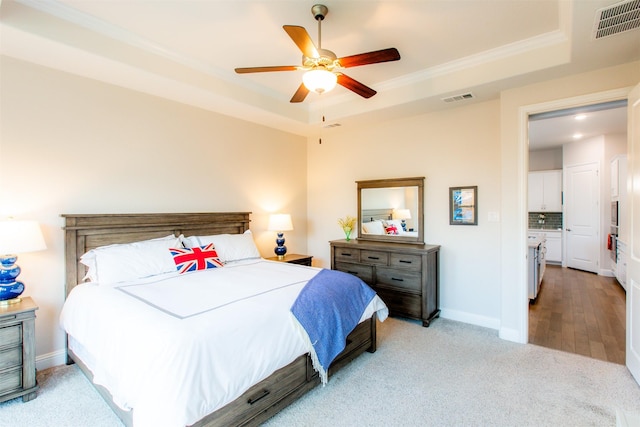 7721 Haddington, The Colony, TX 75056 - bedroom featuring a raised ceiling, light carpet, ornamental molding, baseboards, and ceiling fan