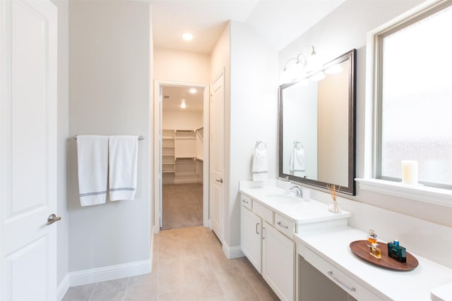 7721 Haddington, The Colony, TX 75056 - bathroom featuring vanity, a spacious closet, baseboards, and recessed lighting