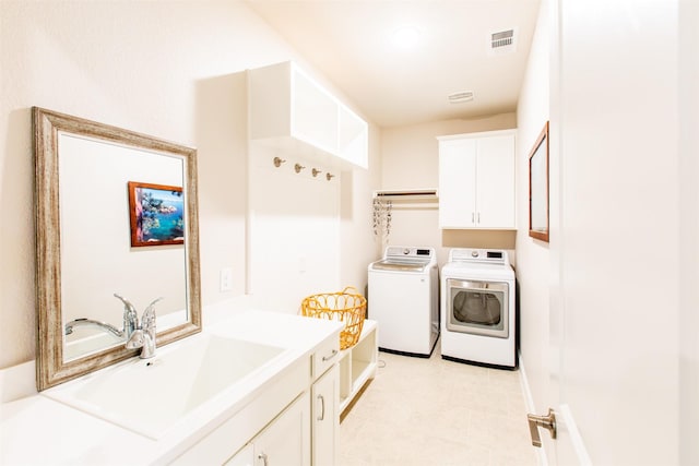 7721 Haddington, The Colony, TX 75056 - washroom with washing machine and clothes dryer, cabinet space, and light tile patterned floors