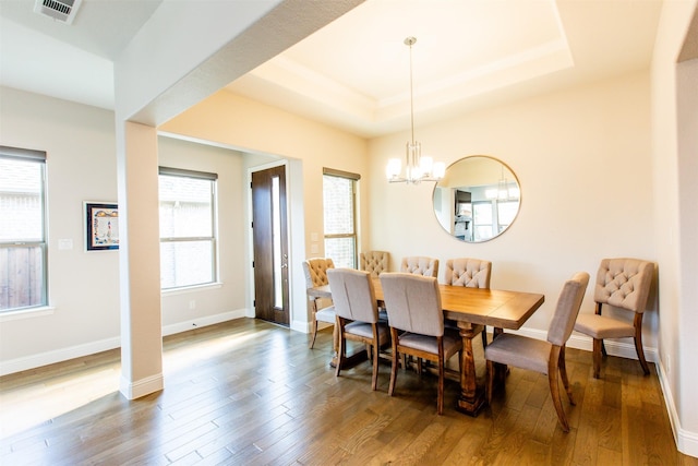 7721 Haddington, The Colony, TX 75056 - dining space with wood finished floors, a chandelier, and a tray ceiling