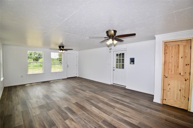 5604 5th St, Rochelle, TX 76872 - empty room with ceiling fan, dark wood-style flooring, a textured ceiling, and baseboards