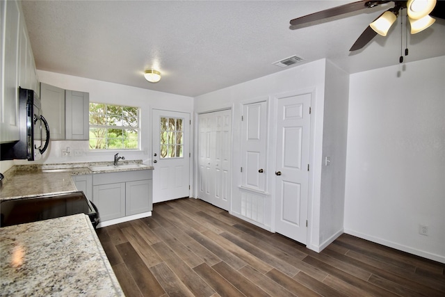 5604 5th St, Rochelle, TX 76872 - kitchen with black appliances, a sink, dark wood finished floors, ceiling fan, and baseboards