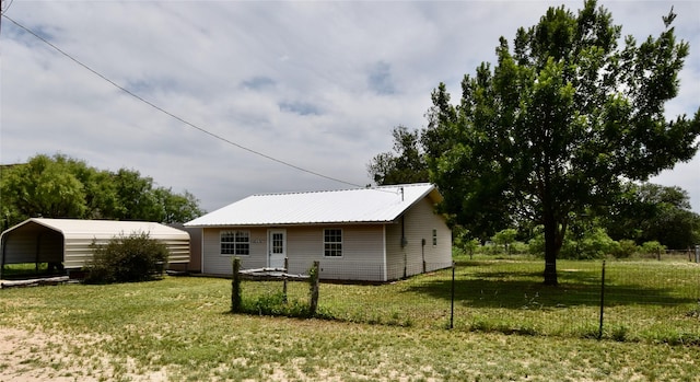 5604 5th St, Rochelle, TX 76872 - view of front of house featuring a detached carport, a front yard, and metal roof