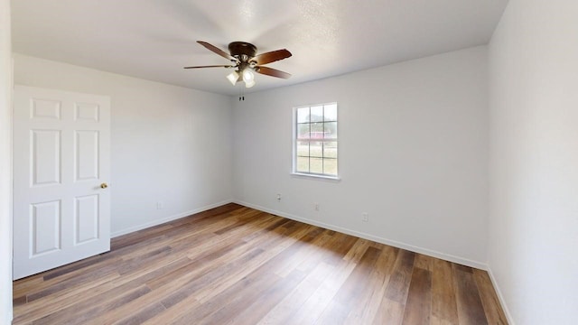 5604 5th St, Rochelle, TX 76872 - unfurnished room with ceiling fan, baseboards, and wood finished floors