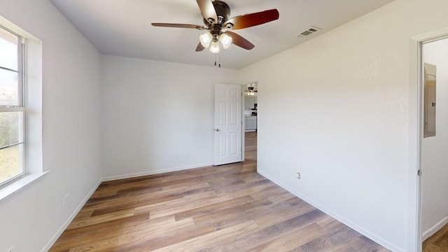 5604 5th St, Rochelle, TX 76872 - empty room with light wood-style flooring, a ceiling fan, baseboards, and electric panel