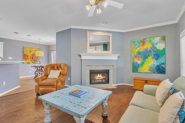 4001 Elmhill Dr, Plano, TX 75024 - living area featuring a ceiling fan, a tiled fireplace, crown molding, baseboards, and wood finished floors